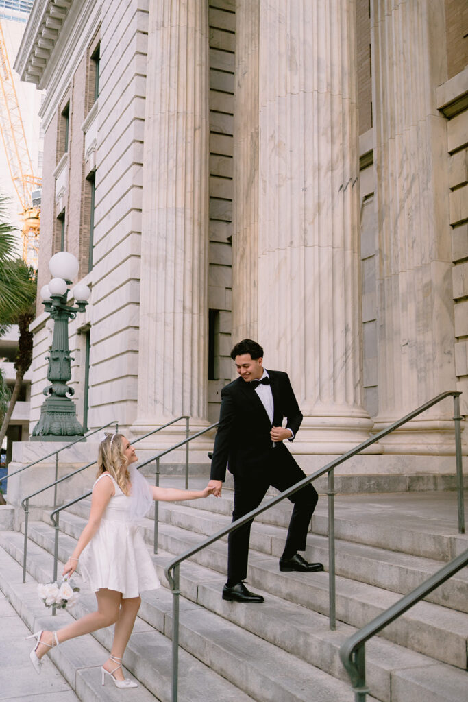Bride lovingly looking at her groom on the steps of Le Meridien Tampa