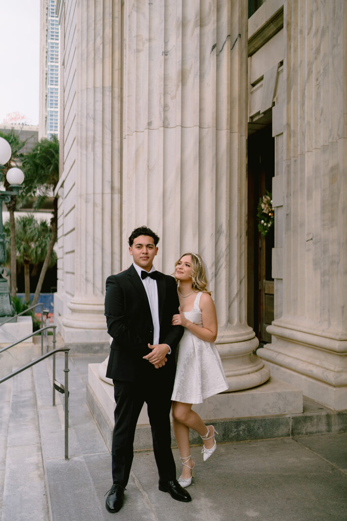 Bride and groom on the steps of Le Meridien Tampa for their wedding photography session