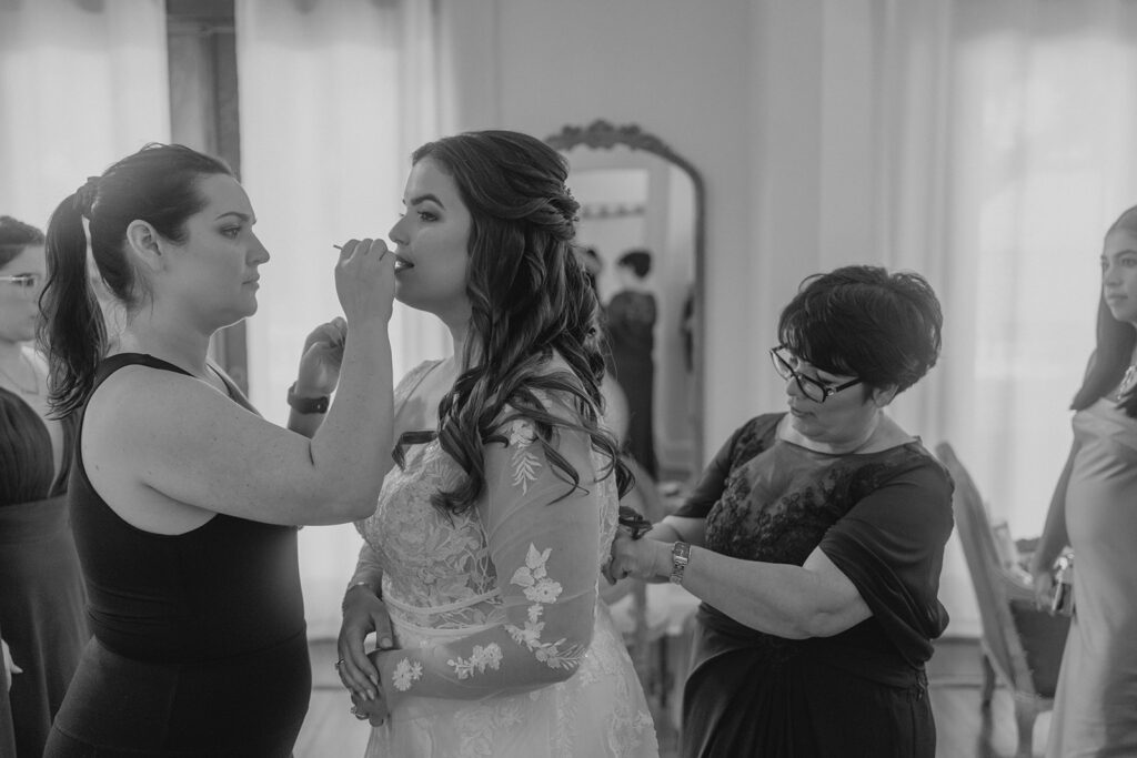 bride having makeup done as she prepares for her wedding at Bella Cosa