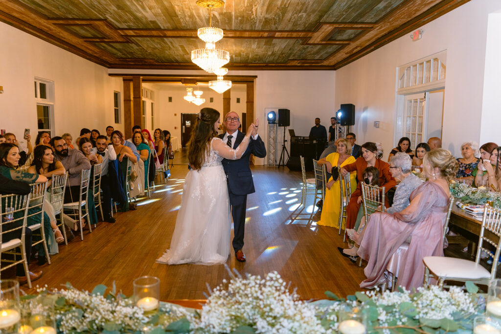 bride dancing with her father, Bella Cosa Wedding reception, emotionally moving father daughter dance with guests in the background