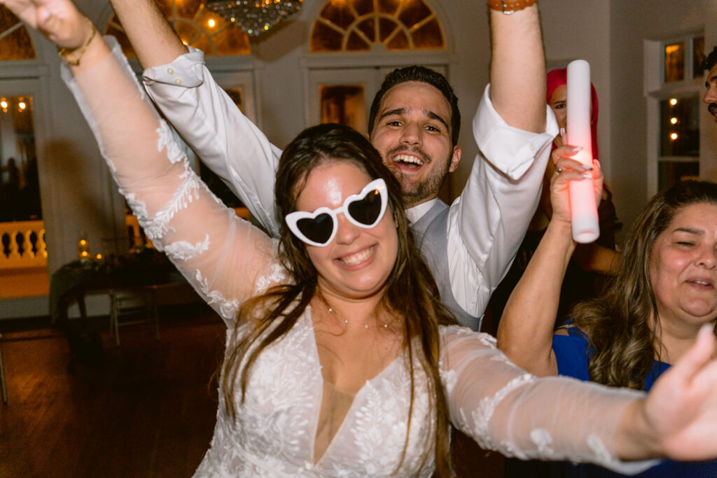 bride and groom smiling for camera in sunglasses at wedding at Bella Cosa wedding venue, photographeed by tampa wedding photographer in lake wales